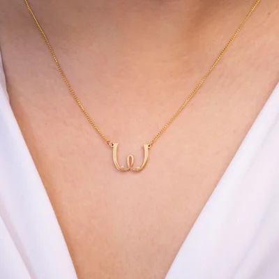 womanizer gold boob necklace